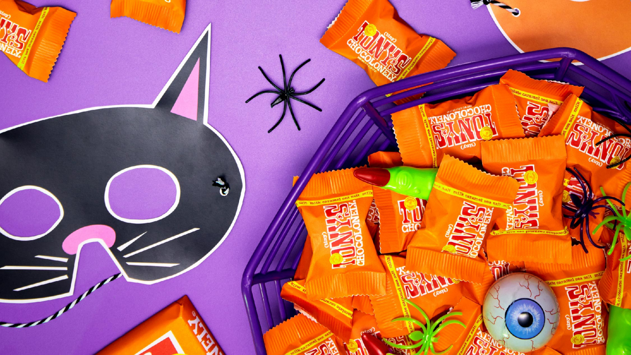 Tony's Chocolonely Halloween Tiny Tony's in a bowl with Halloween decorations and props